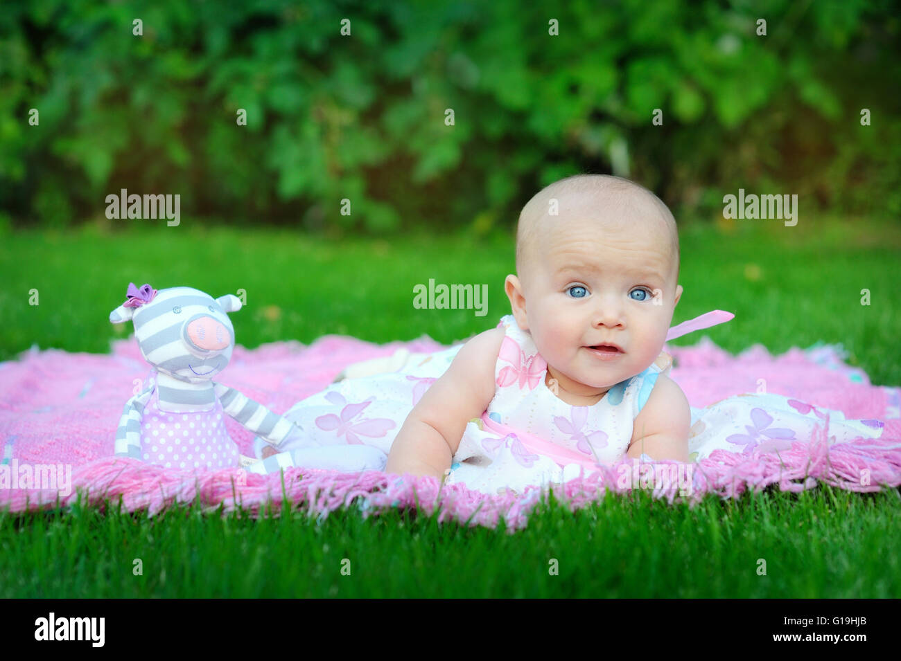 little pretty girl playing on the lawn Stock Photo