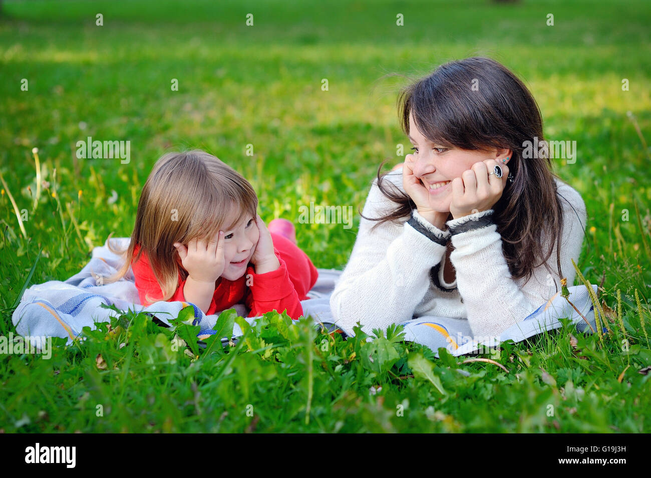 Portrait of smiling beautiful young woman and her little daughte Stock Photo