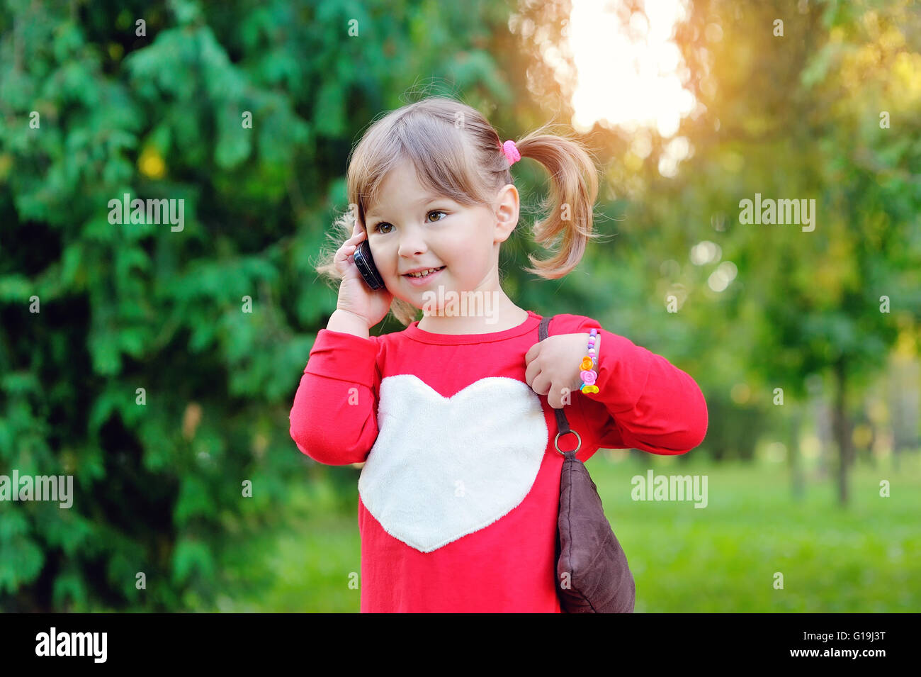 little girl speaks by phone Stock Photo
