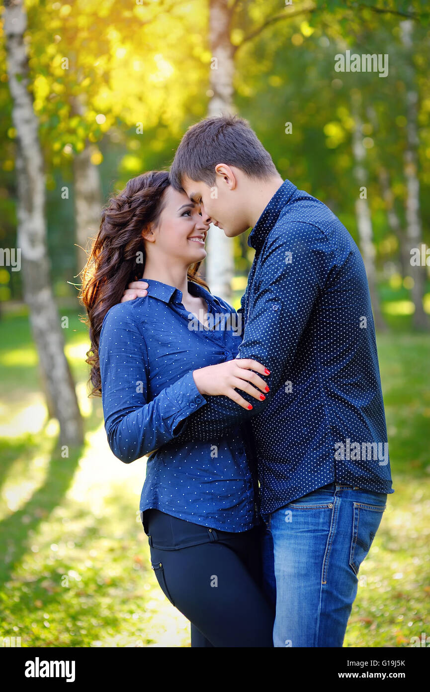 Romantic Teenage Couple By Tree In Autumn Park Stock Photo