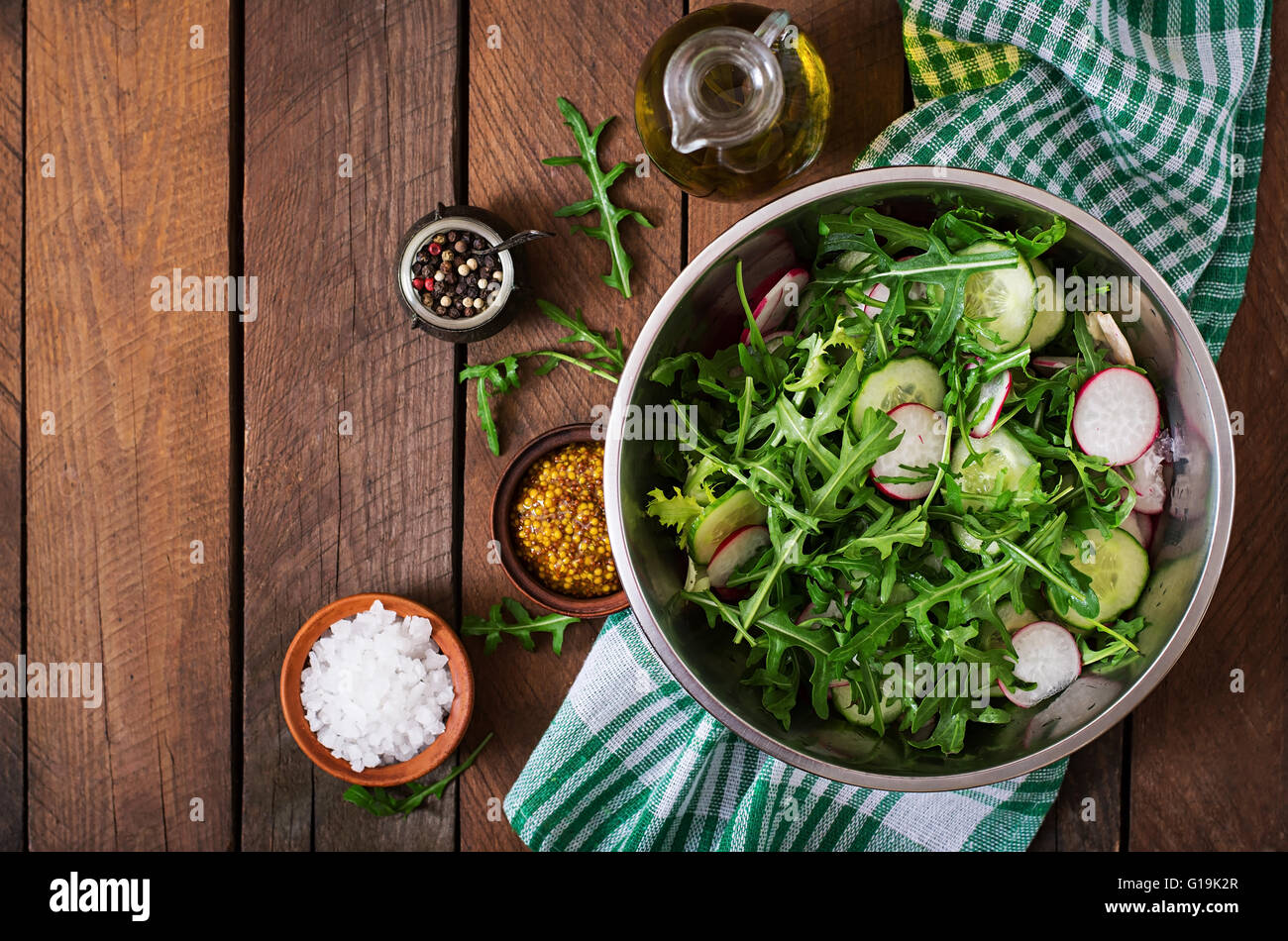 Ingredients for Salad arugula, radish, cucumber and spices. Top view
