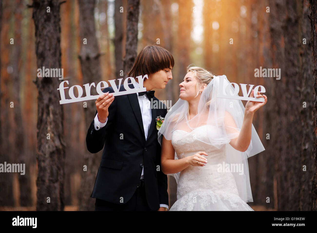 bride and groom kissing in the woods Stock Photo - Alamy