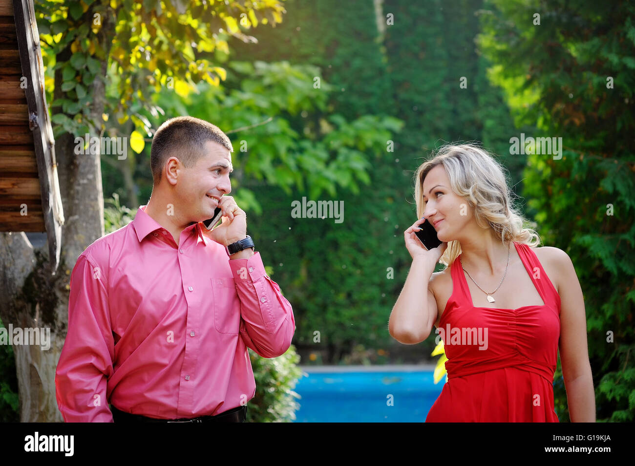 girl and guy talking on the phone park Stock Photo