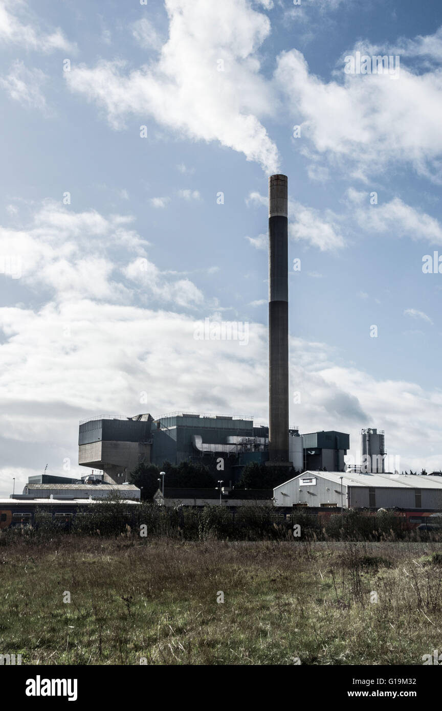 Industrial building with tall chimney Stock Photo