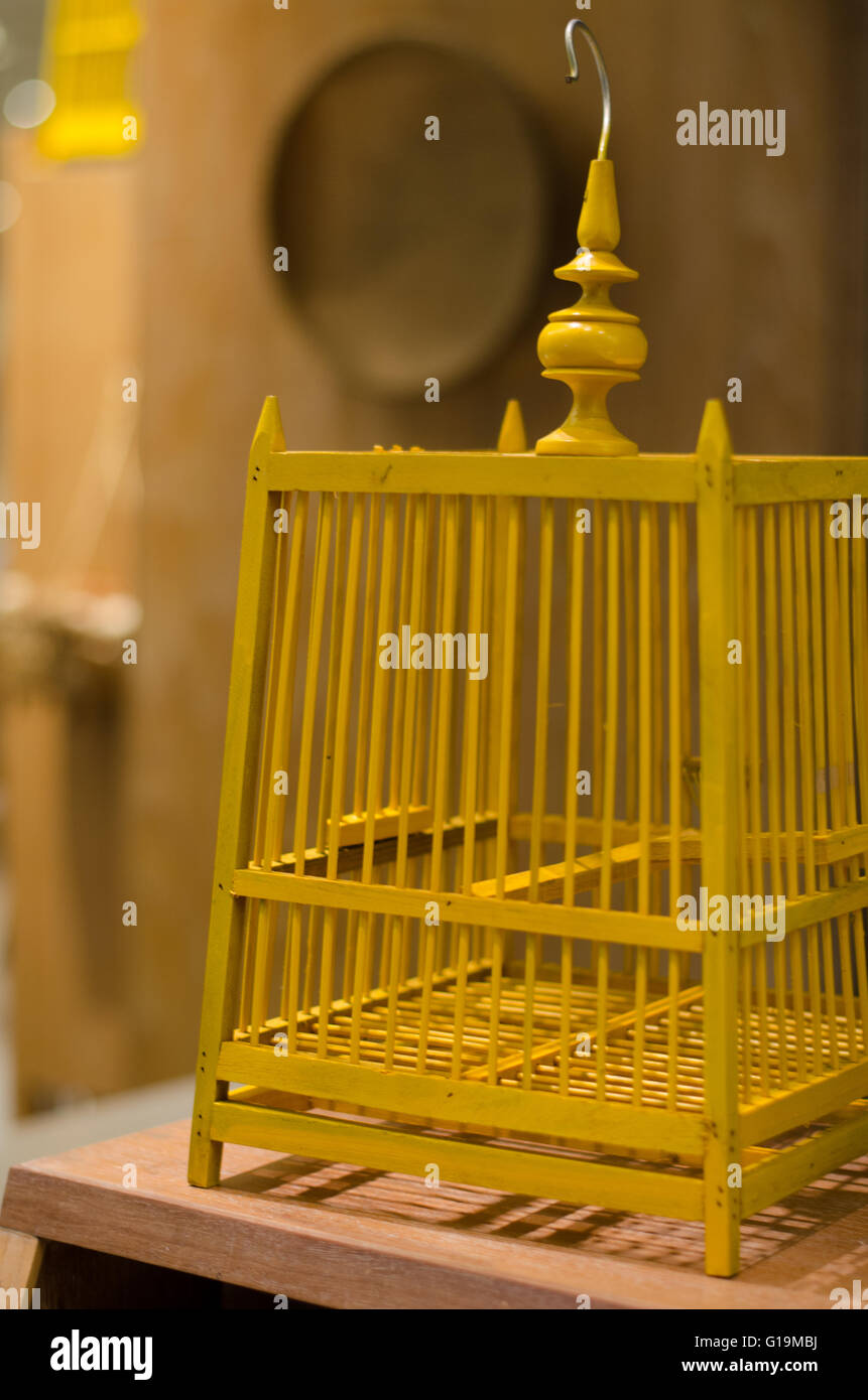 Golden bird cage on blurry background of thailand kitchen. Selective
