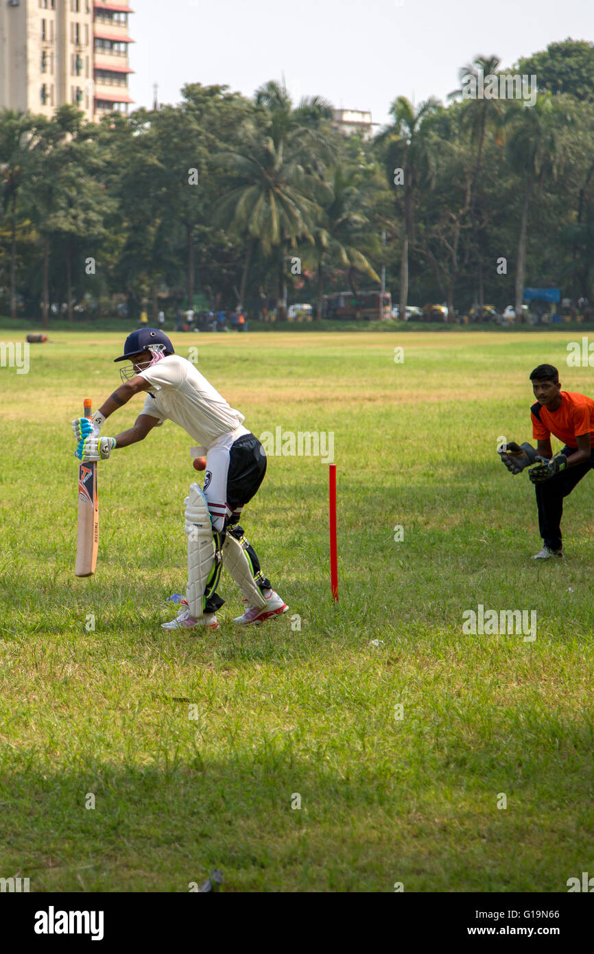MUMBAI, INDIA - OCTOBER 10, 2015: People playing cricket in the central park at Mumbai, India. Cricket is the most popular sport Stock Photo