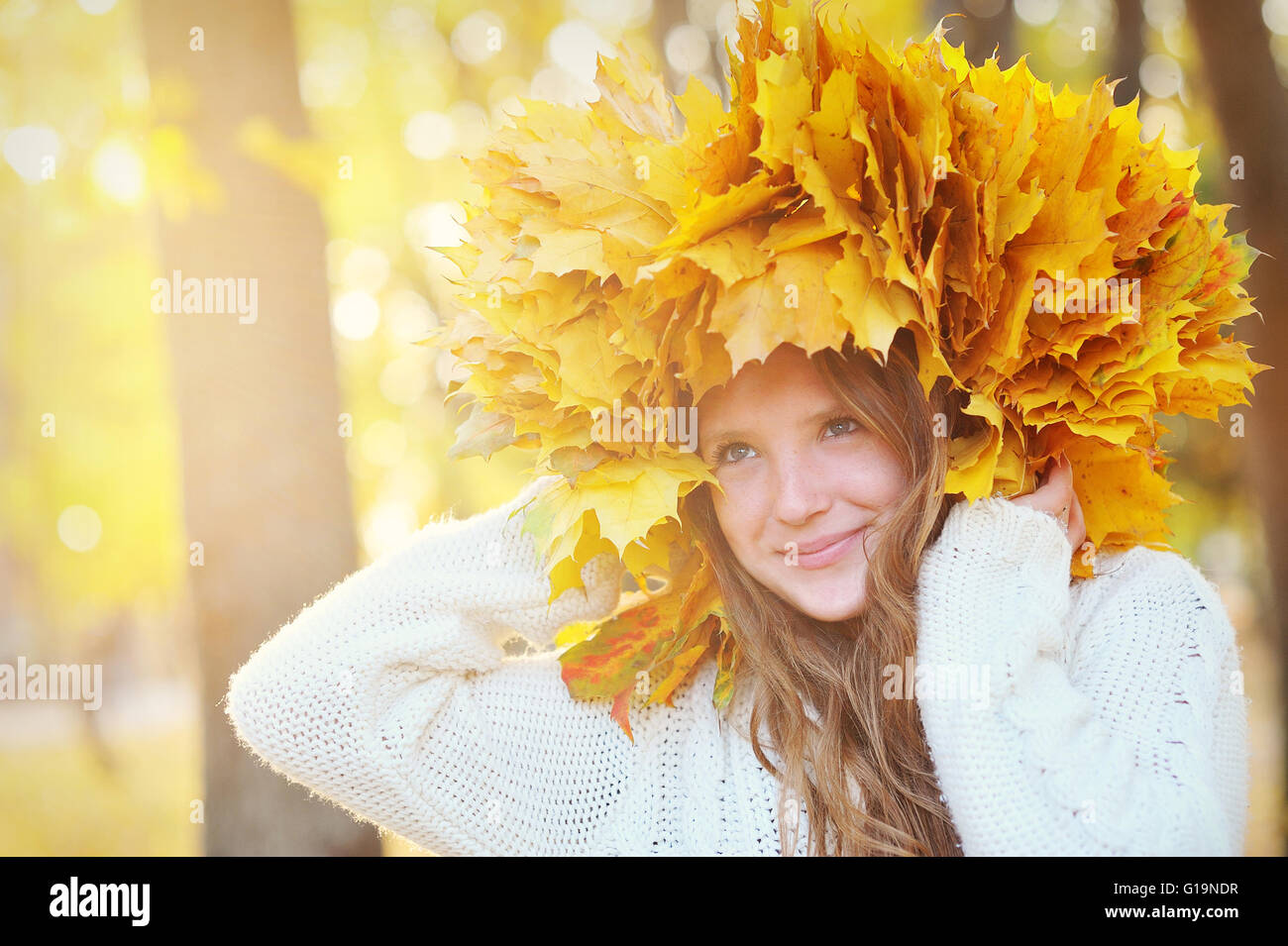 Young beautiful girl with autumn leaves in his hand, and the wre Stock Photo