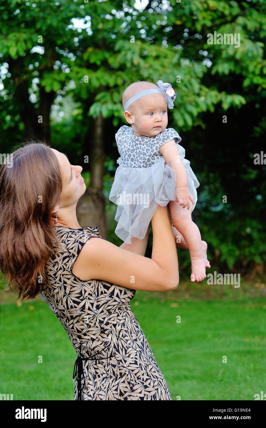 Beautiful Mother And Baby outdoors. Nature. Beauty Mum and her C Stock Photo