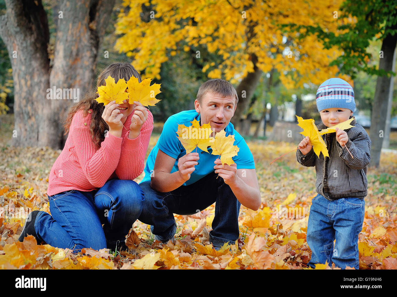 Happy beautiful family relaxing in autumn park Stock Photo