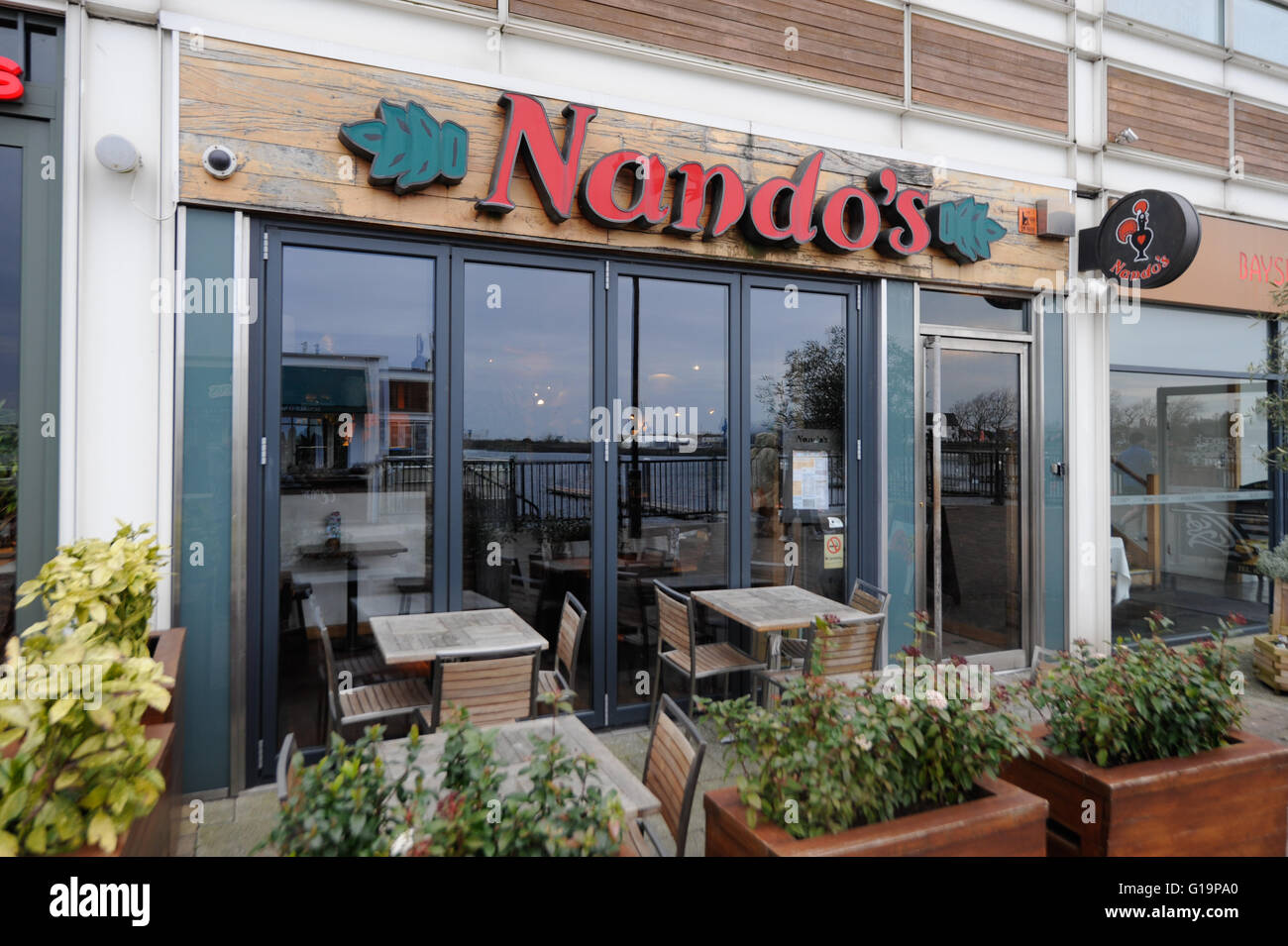 Nando's Restaurant exterior sign in Cardiff Bay - United Kingdom Stock Photo