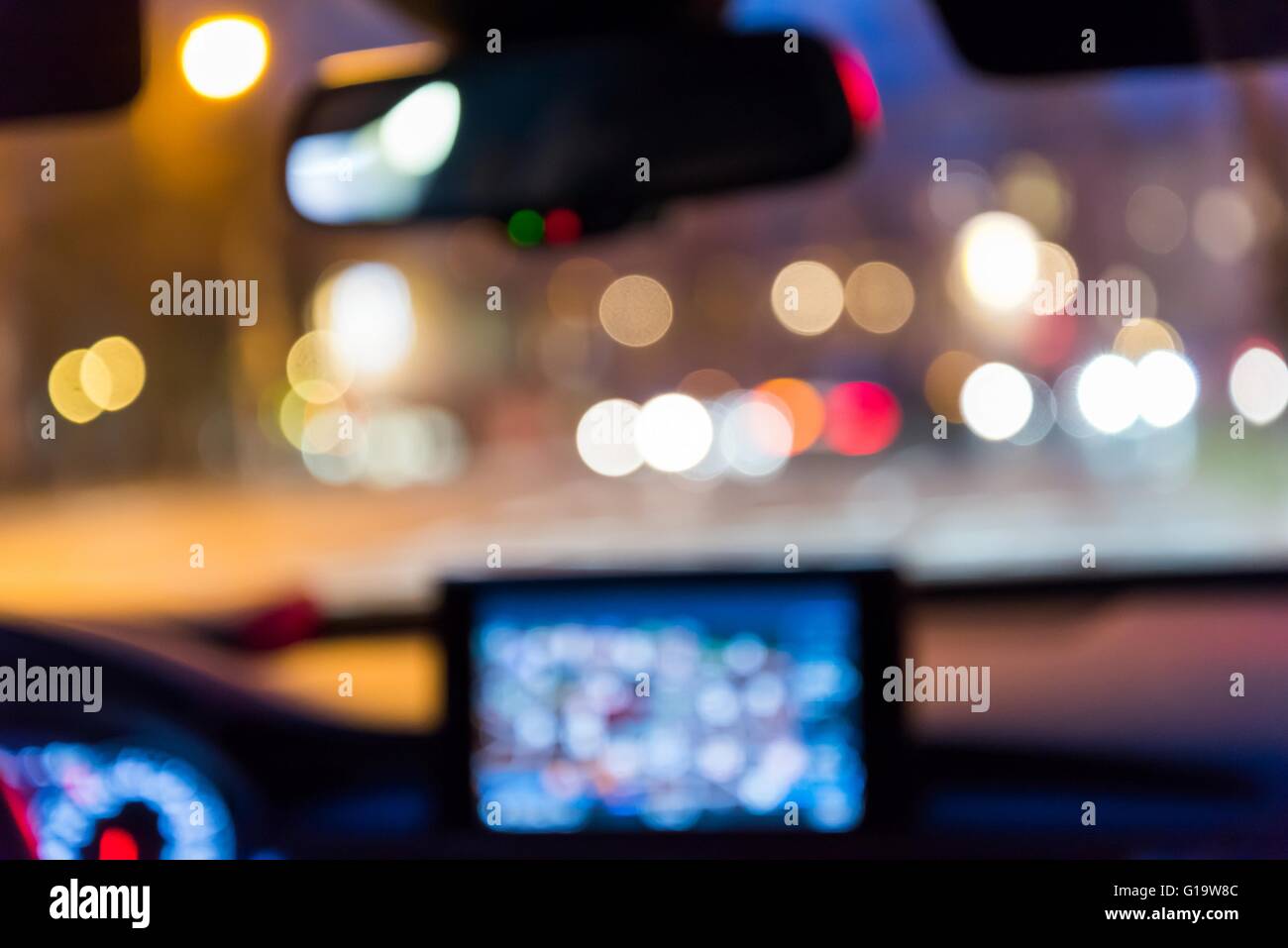 Inside car with bokeh lights from traffic jam on night time for background. Blur image Stock Photo