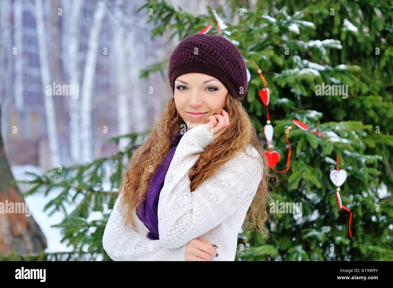 beautiful girl in winter on a background of trees Stock Photo