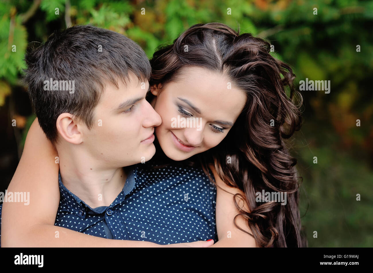 the love of man and woman in the park, woman hugging guy Stock Photo