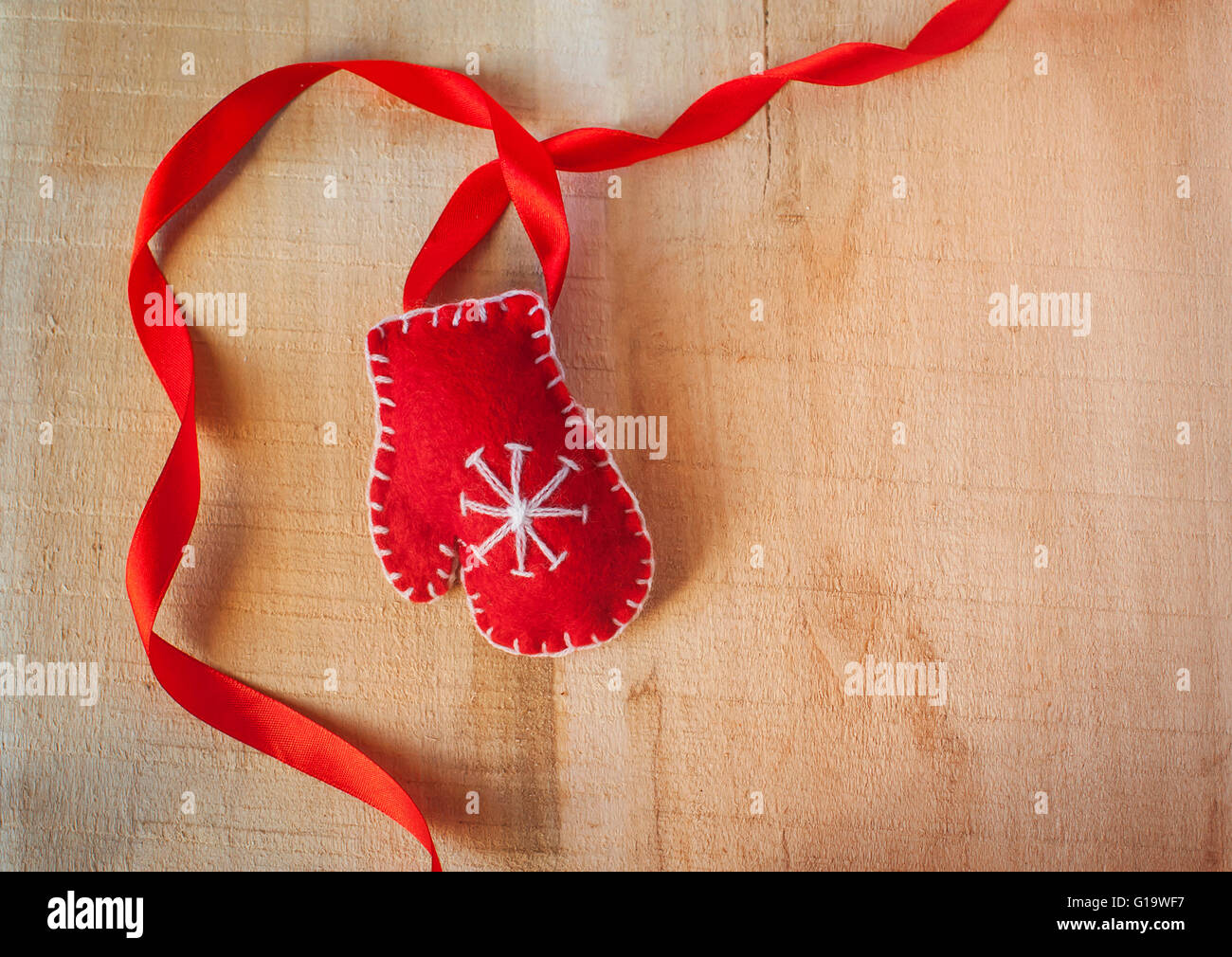 Christmas frame with Santa Claus red mittens on a wooden backgro Stock Photo