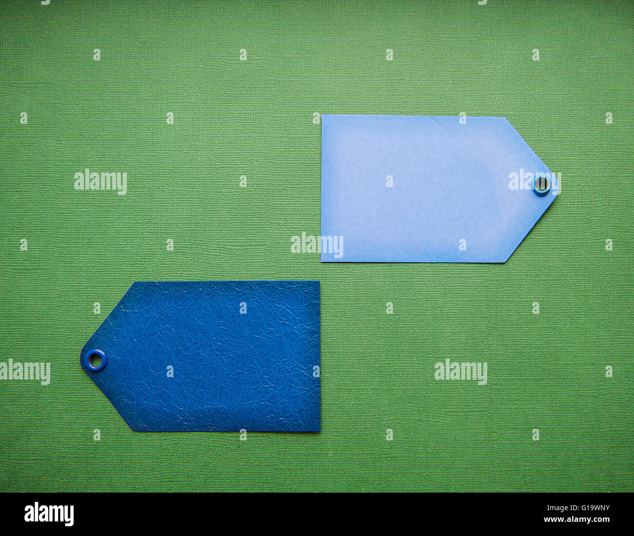 two blue label sale on a green background Stock Photo Alamy