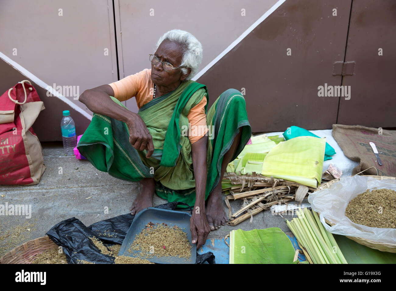 A lady sells spices in a busy street in Chennai India Stock Photo Alamy
