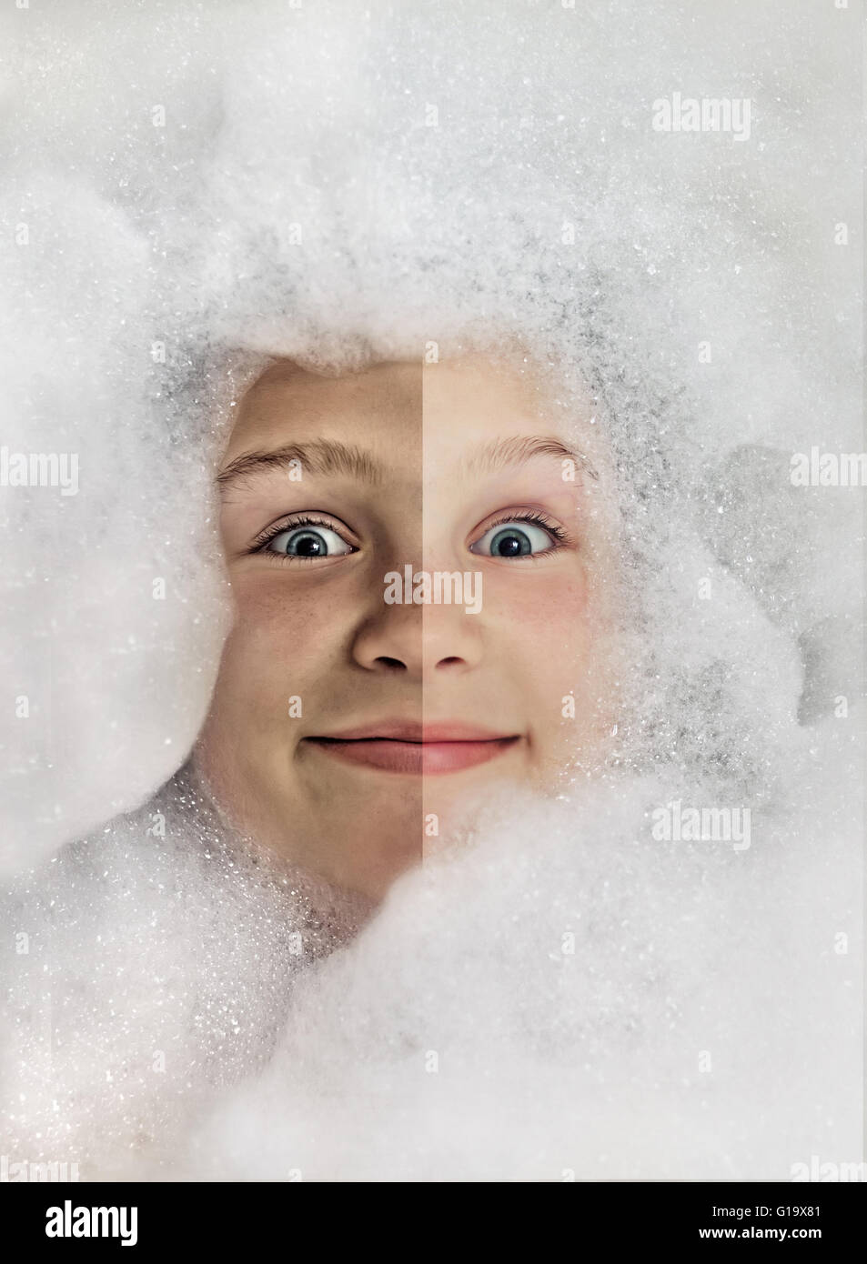 Funny little girl in a bubble bath filled with soap foam, before bath