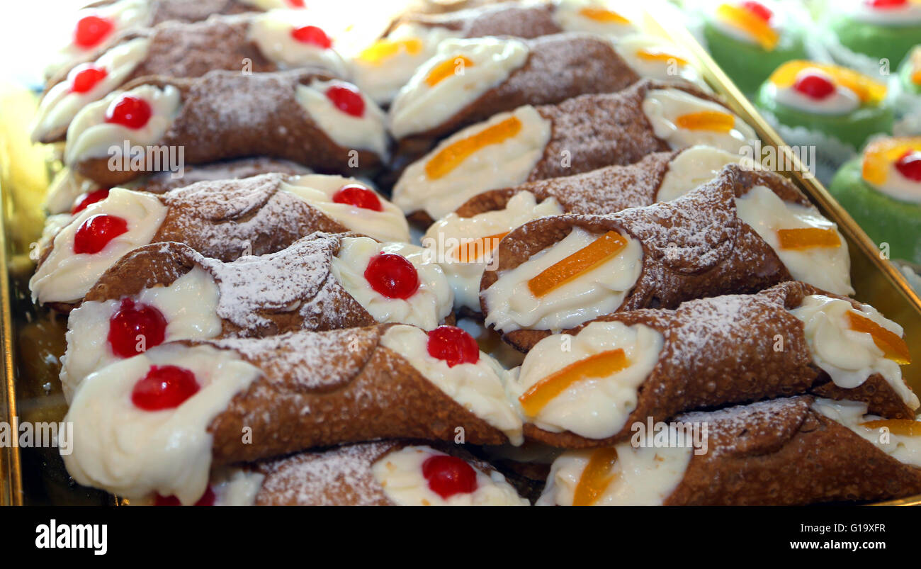 many Sicilian cannoli with custard and cherries or candied fruit Stock