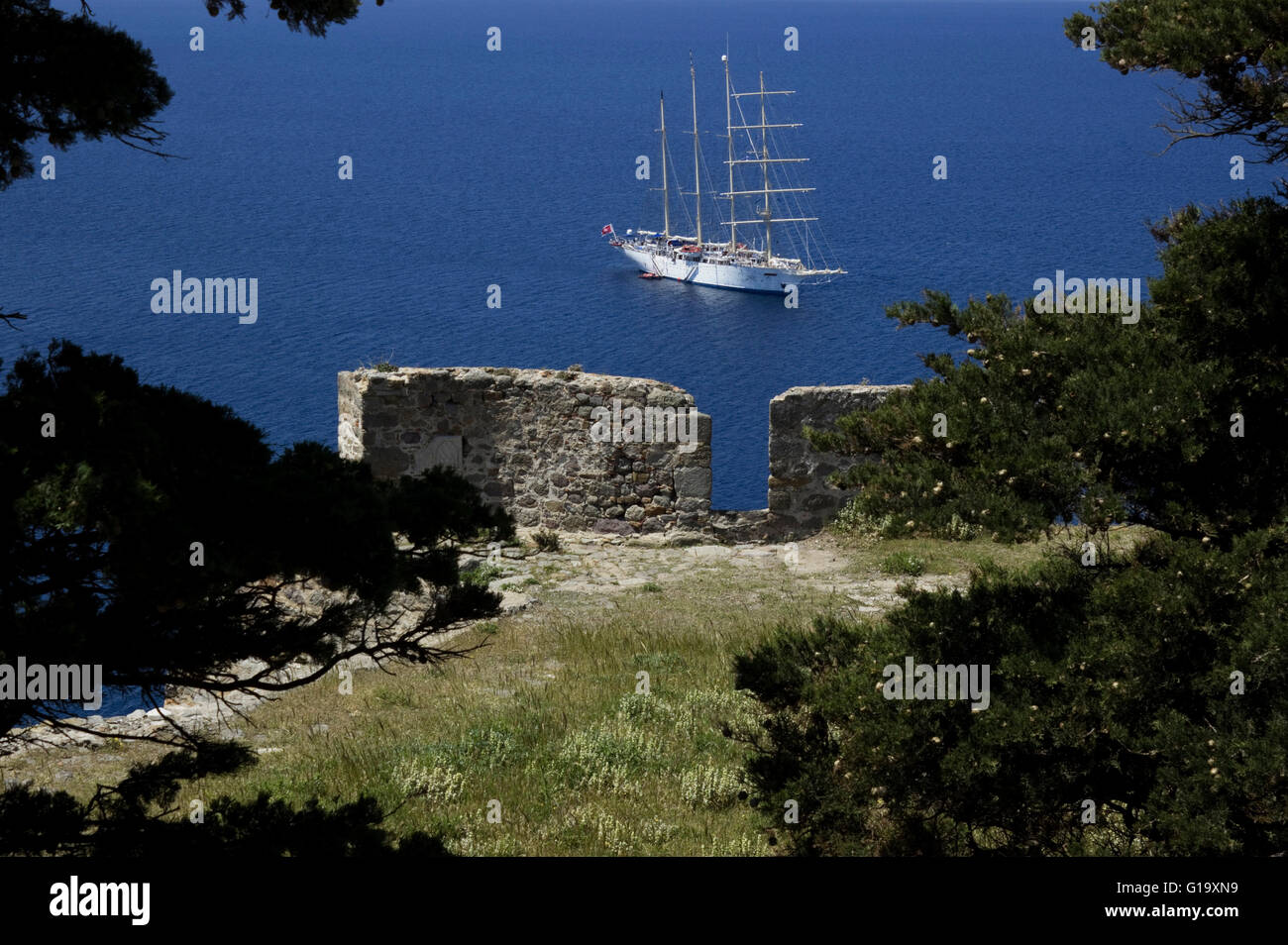 Luxurious Star Clipper ship sailing in the Aegean ocean, anchored outside Myrina's harbour. View from the castle. Limnos Greece Stock Photo