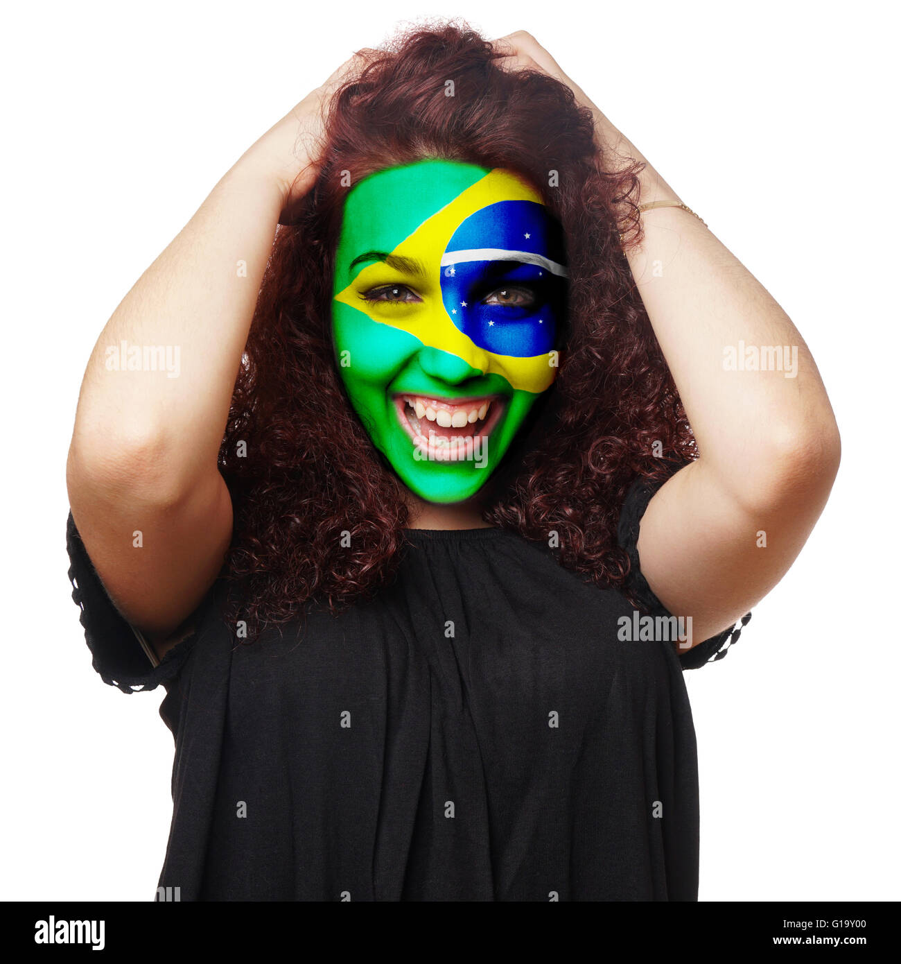 girl with brazilian flag face paint Stock Photo