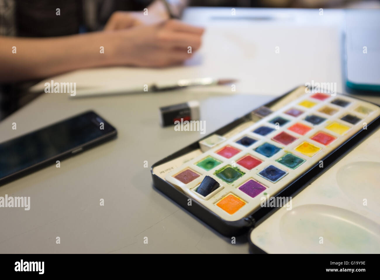 A-Level art lesson at a UK comprehensive school with a palette of paints Stock Photo