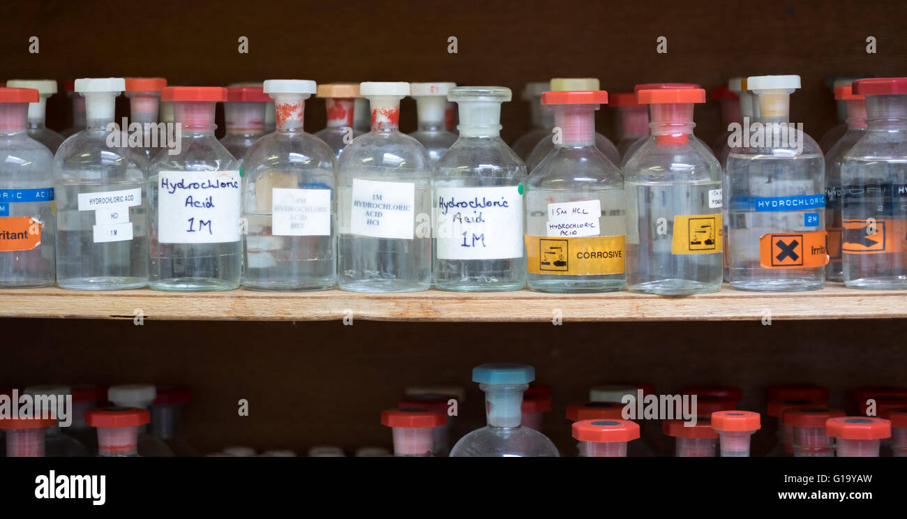 Glass storage jars containing chemicals in a school laboratory Stock