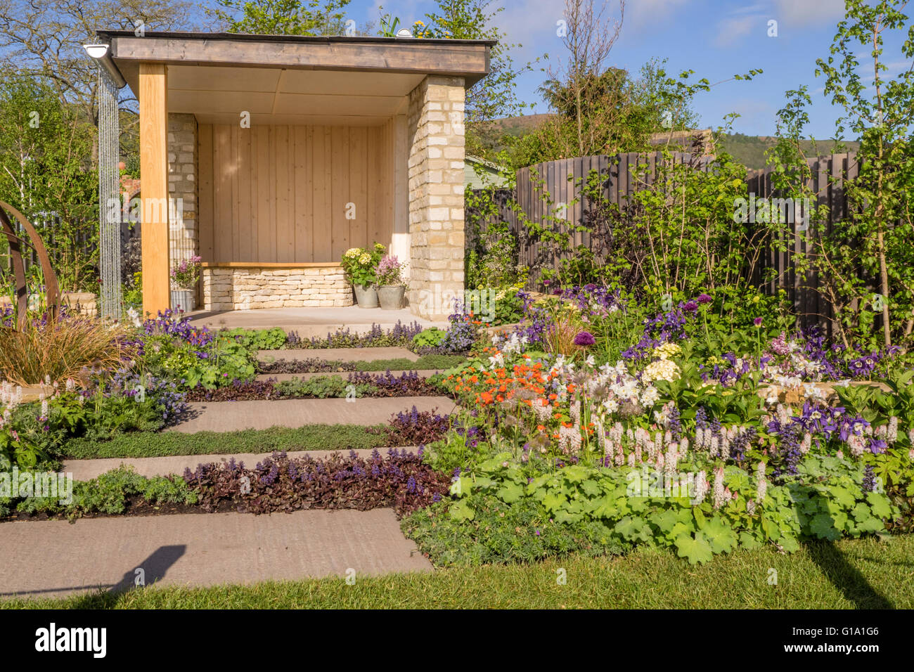 spring garden with creative planting in the path and border Stock Photo ...