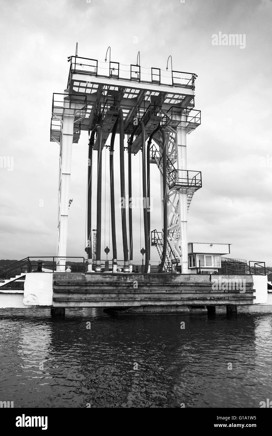 Oil terminal. Equipment for tankers loading on the pier, black and white photo Stock Photo