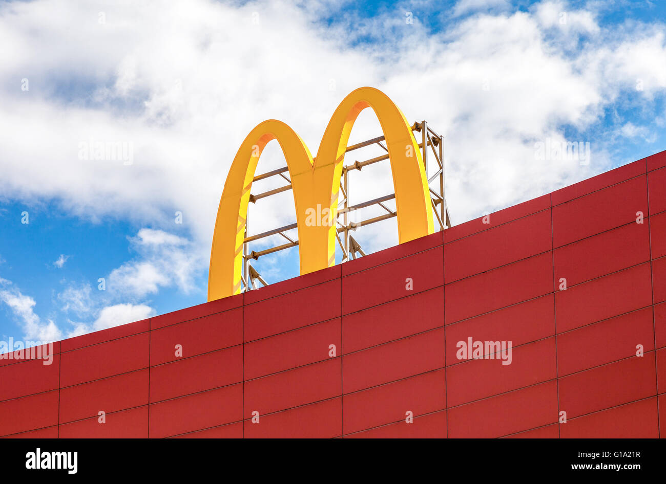 McDonald's logo against the blue sky Stock Photo