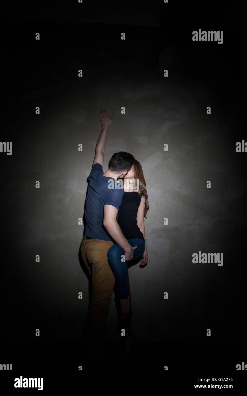 Young couple embracing over gray background Stock Photo