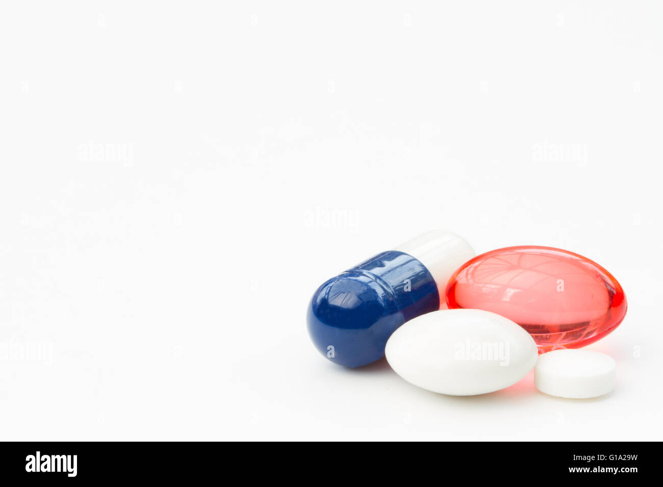 A variety of painkilling drugs in the form of pills and tablets on an isolated white background. Stock Photo