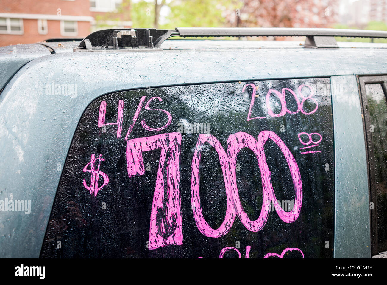 An owner writes the pertinent information on the window of his 8-year old vehicle for sale in the Chelsea neighborhood of New York, seen on Friday, May 6, 2016. (© Richard B. Levine) Stock Photo