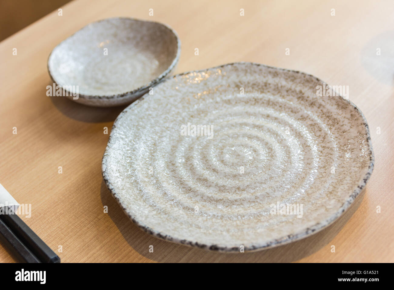 empty spiral pattern plate on wood table Stock Photo