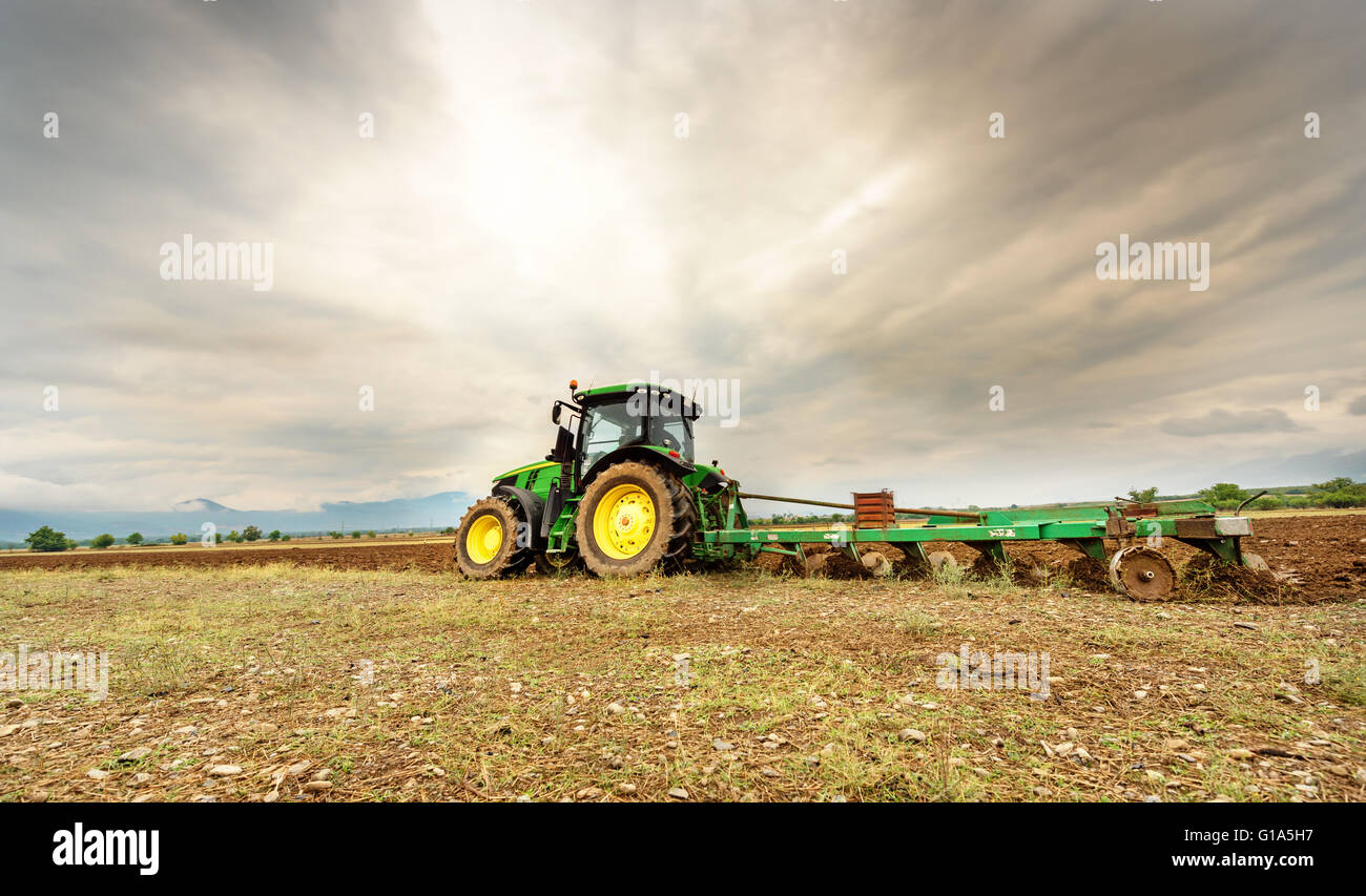 Karlovo, Bulgaria - August 22th, 2015: Ploughing a field with John Deere 7230R tractor. John Deere 8100 was manufactured in 1995 Stock Photo