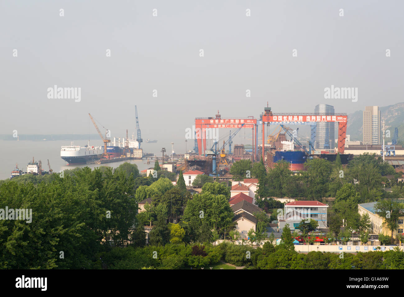 Chinese economy with Chang Jiang National Shipping shipyard along the Yangtze river in Nanjing, China Stock Photo