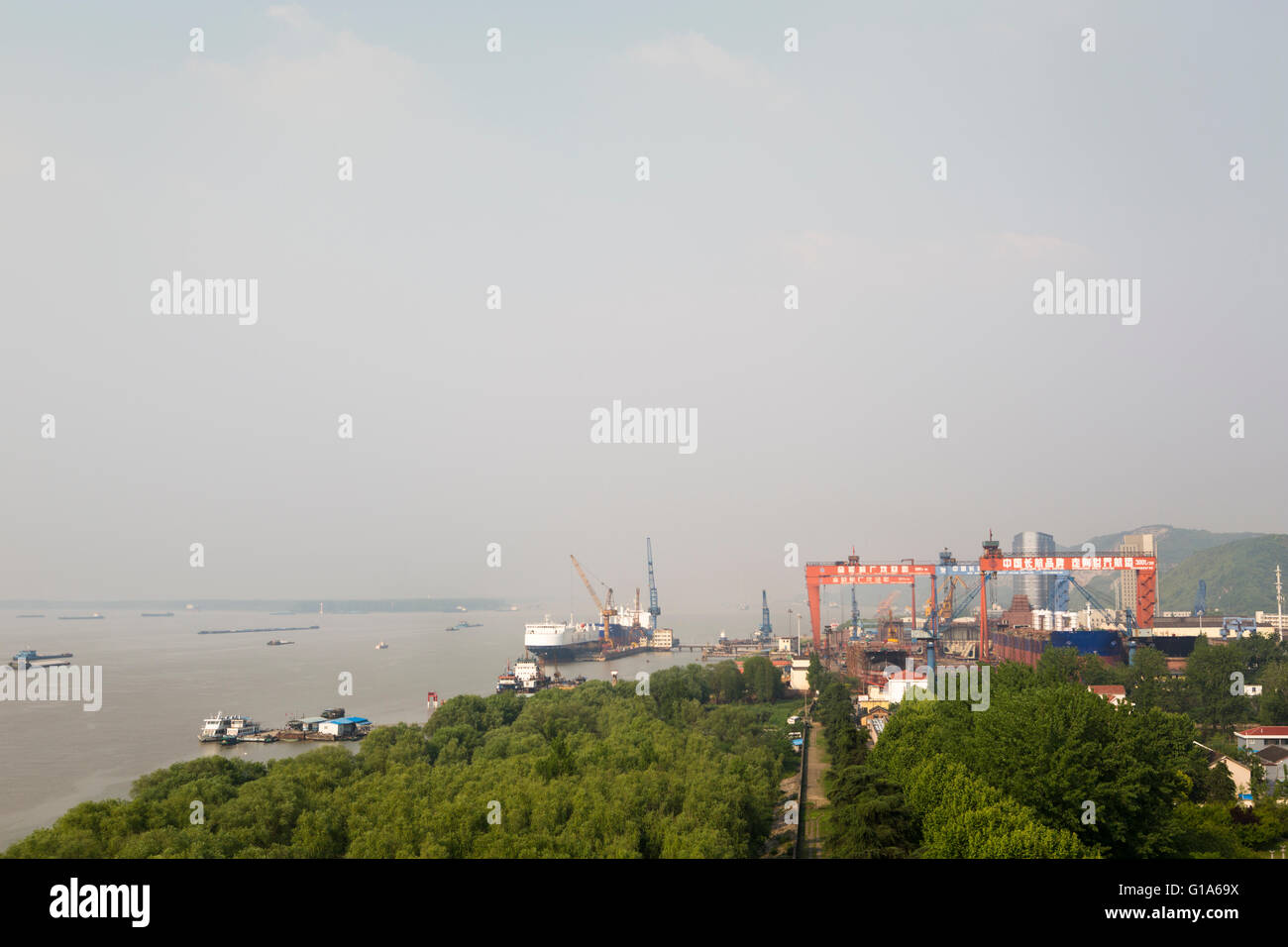 Chinese Shipyard along hazy Yangtze river in Nanjing, China Stock Photo