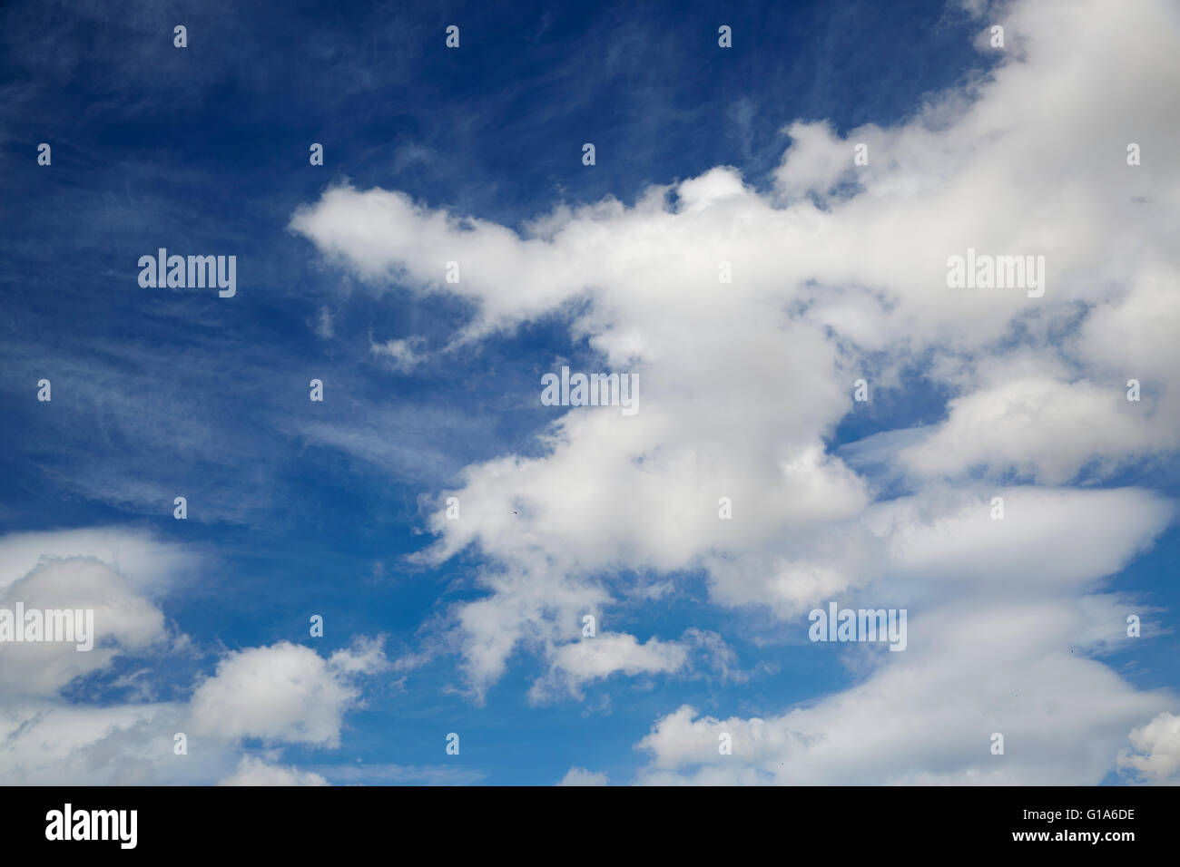 A bright blue sky on a sunny day with fluffy white clouds Stock Photo ...