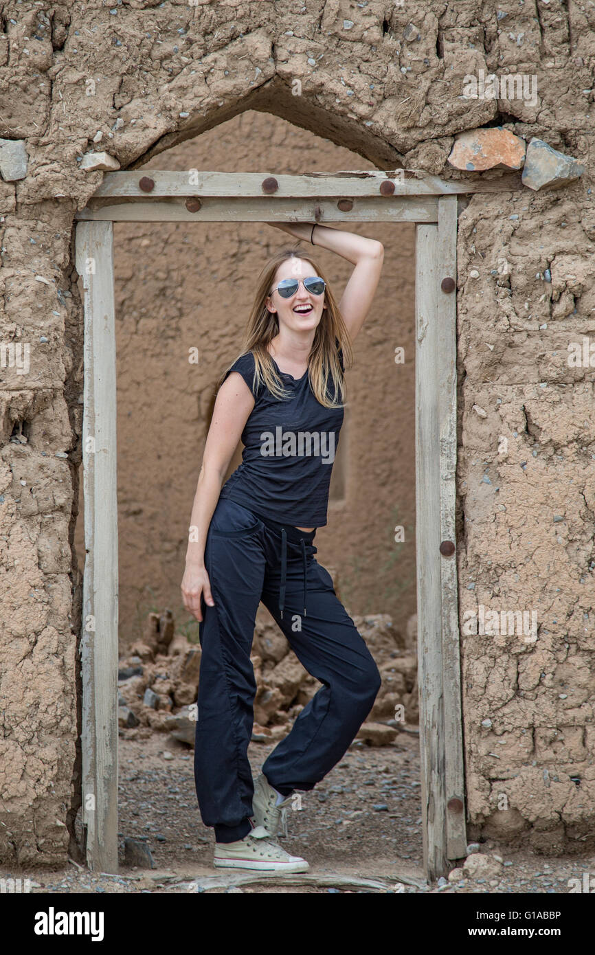 A young woman in a doorway of old abandoned house in Oman Stock Photo ...