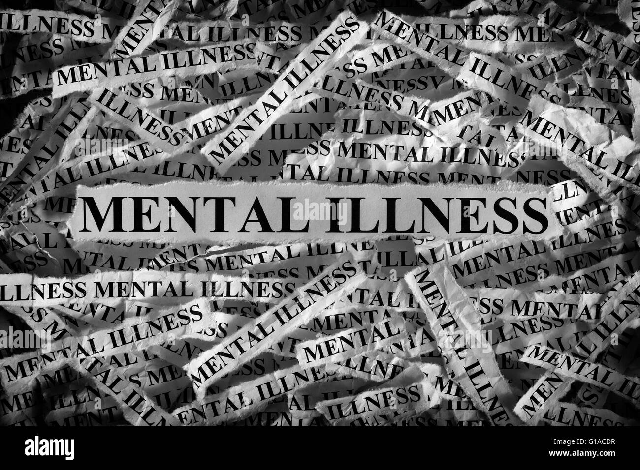Mental illness. Torn pieces of paper with the words Mental illness. Concept Image. Black and White. Closeup. Stock Photo