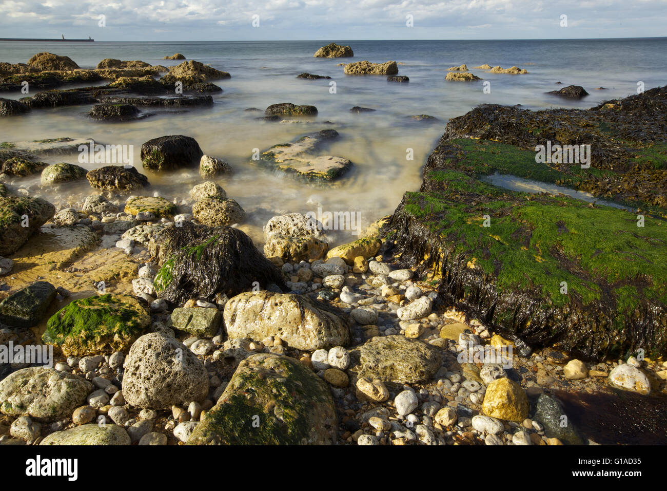 Sea shore with stones and waves Stock Photo - Alamy