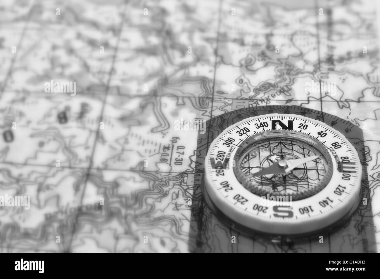 Tools for the journey - a map and a compass. Magnetic compass is located on a topographic map. Stock Photo