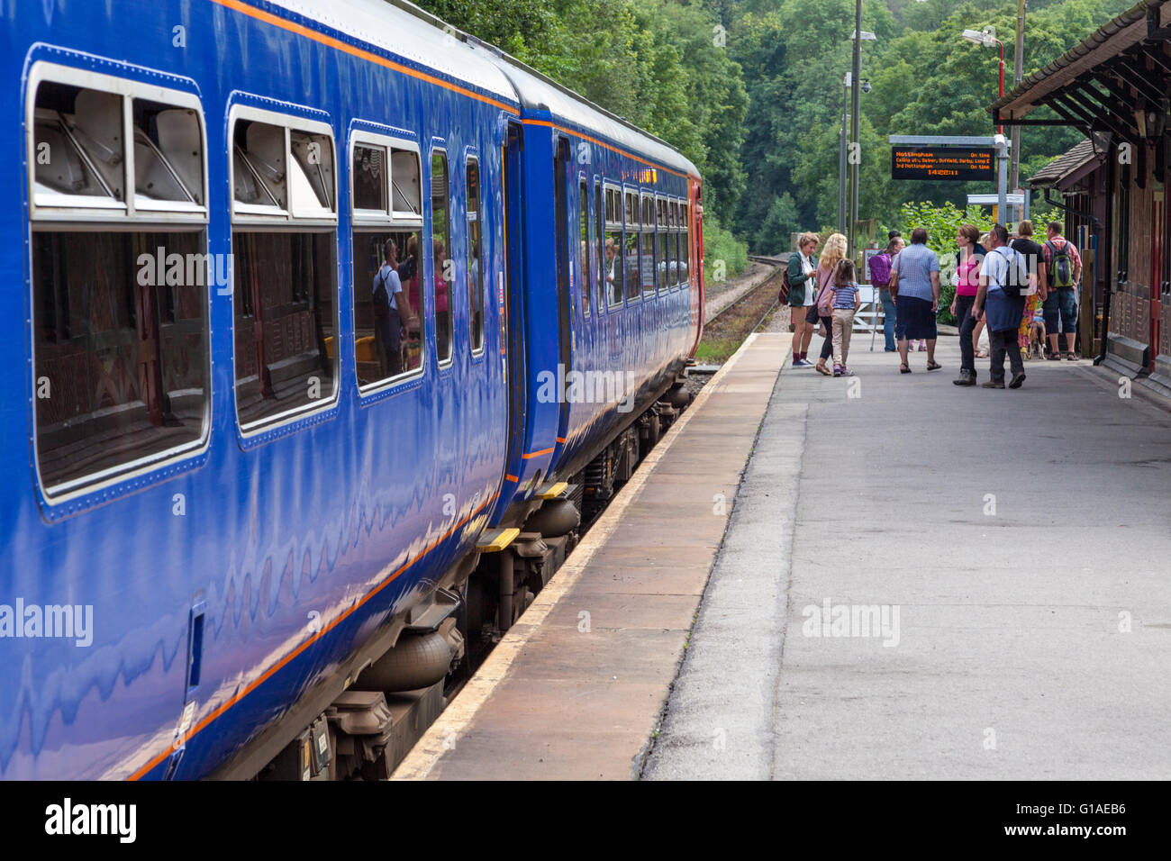 Passengers leaving a train at a rural railway station. Matlock Bath Station, Derbyshire, England, UK Stock Photo