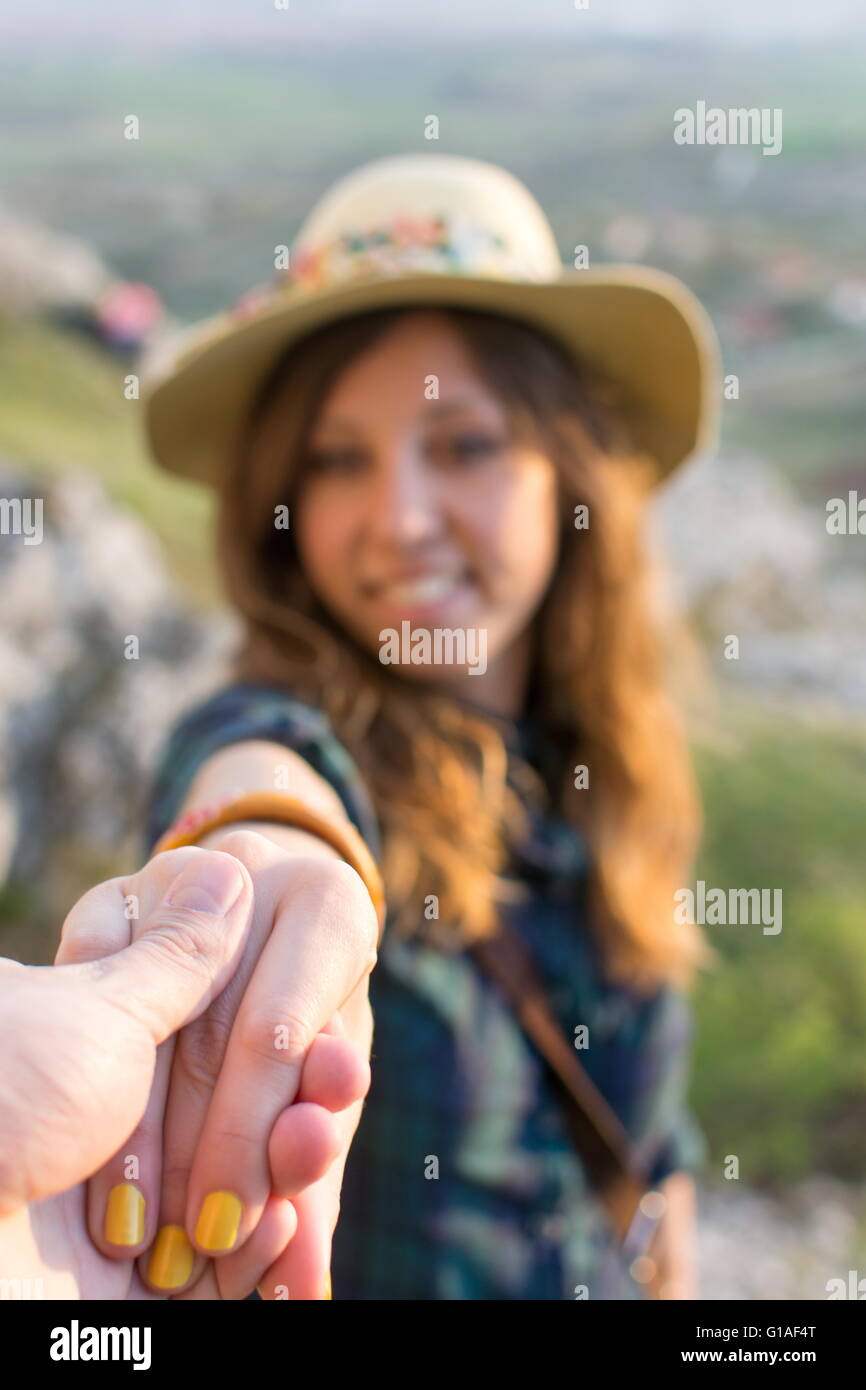 Take my hand. Couple of hikers holding hands Stock Photo