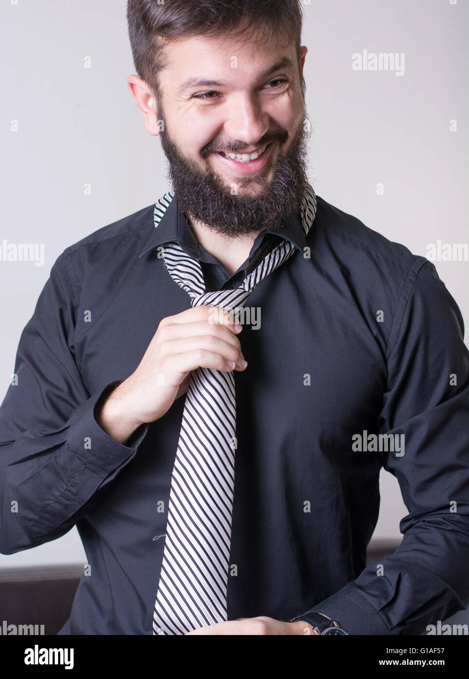Man trying out a striped tie Stock Photo