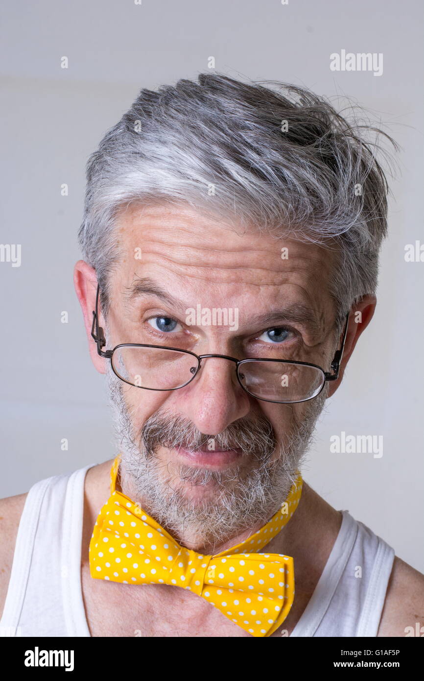 Funny senior man with a bow tie arround his neck Stock Photo