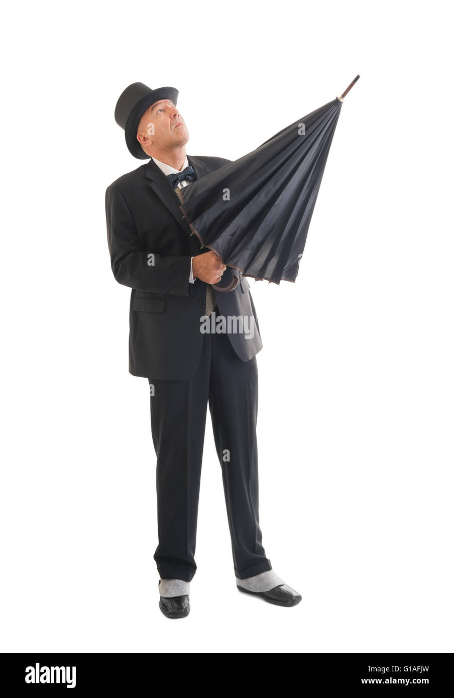 Middle aged  businessman in a retro business suit with umbrella isolated on white. Stock Photo