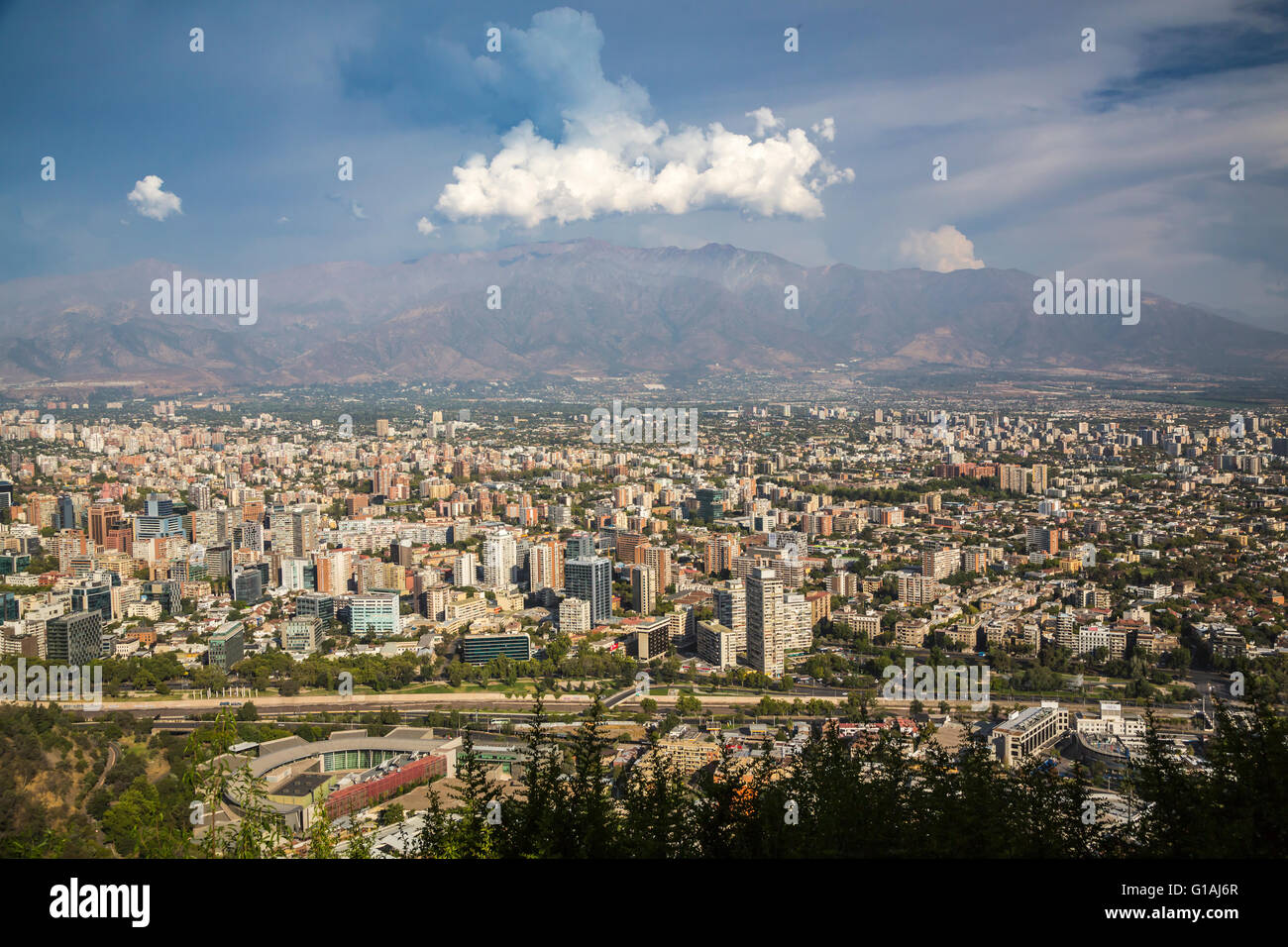 The city skyline with clouds over the Andes Mountains in Santiago, Chile, South America. Stock Photo