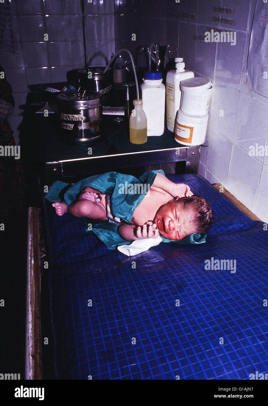 A newly born baby just five minutes old on a bench in Kismayo hospital Somalia Stock Photo
