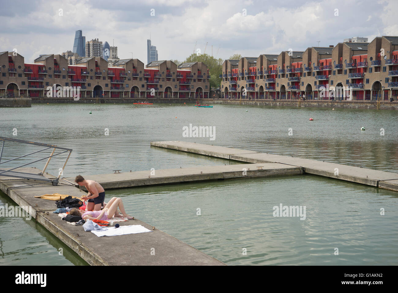 Couple sunbathing in Shadwell Basin in Wapping London UK Stock Photo ...