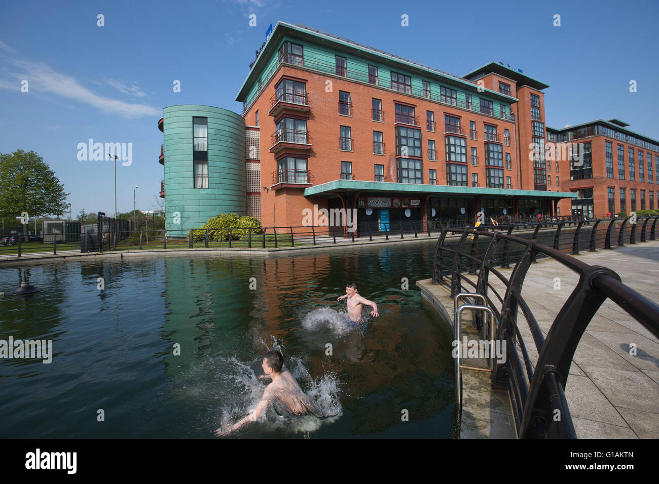 Local kids play in the water feature at Gasworks Path, Gasworks site, Belfast County Antrim, Northern Ireland Stock Photo